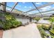 Covered courtyard with brick and concrete flooring, lush landscaping, and a water feature at 2305 Se 8Th St, Ocala, FL 34471