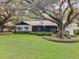 Side yard view of a mid-century modern home at 2305 Se 8Th St, Ocala, FL 34471