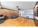 Bright Gathering room features hardwood floors, built-in shelving, and a brick accent wall at 2305 Se 8Th St, Ocala, FL 34471