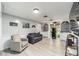 Game room with a large TV, sectional sofa, and game shelves at 2305 Se 8Th St, Ocala, FL 34471