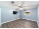 Bedroom with light blue walls, wood-look floors, and ceiling fan at 2305 Se 8Th St, Ocala, FL 34471