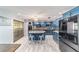 Renovated kitchen featuring blue cabinetry, granite island, and breakfast bar at 2305 Se 8Th St, Ocala, FL 34471