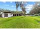 Large backyard with lush grass and a white house at 2305 Se 8Th St, Ocala, FL 34471