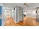 Long hallway with light walls and hardwood floors leading to other rooms at 2305 Se 8Th St, Ocala, FL 34471