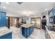 Open kitchen boasting blue cabinets, granite countertops, and an island at 2305 Se 8Th St, Ocala, FL 34471