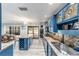 Spacious kitchen with blue cabinets, granite countertops, and island with wine rack at 2305 Se 8Th St, Ocala, FL 34471