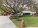 Driveway and front yard of a mid-century modern home at 2305 Se 8Th St, Ocala, FL 34471