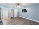 Bedroom with light blue walls, wood-look floors, and ceiling fan at 2305 Se 8Th St, Ocala, FL 34471