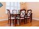 Formal dining room features hardwood floors and a large table with six chairs at 15890 Sw 11Th Terrace Rd, Ocala, FL 34473