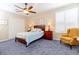 Spacious bedroom with carpeted floor, ceiling fan, and large window with plantation shutters at 15890 Sw 11Th Terrace Rd, Ocala, FL 34473