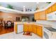 Spacious kitchen with oak cabinets, a breakfast bar, and a view of the dining area at 15890 Sw 11Th Terrace Rd, Ocala, FL 34473