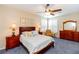 Main bedroom with carpeted floor, ceiling fan, and plenty of natural light at 15890 Sw 11Th Terrace Rd, Ocala, FL 34473