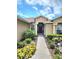 Front entrance with a walkway, landscaping and a dark-colored door at 15890 Sw 11Th Terrace Rd, Ocala, FL 34473