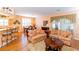 Living room with hardwood floors, couches and a view to the kitchen and dining area at 15890 Sw 11Th Terrace Rd, Ocala, FL 34473
