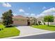 One-story house with a two-car garage and landscaped yard with palm trees at 15890 Sw 11Th Terrace Rd, Ocala, FL 34473