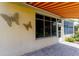 Exterior view of patio with striped awning and metal butterfly decor at 15890 Sw 11Th Terrace Rd, Ocala, FL 34473