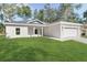 Single-story home with gray roof, attached garage, and well-manicured lawn at 5 Emerald Trl, Ocala, FL 34472