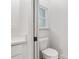 Small bathroom with toilet and window at 5 Emerald Trl, Ocala, FL 34472