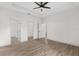 Spacious bedroom with wood-look floors, ceiling fan and ample closet space at 5 Emerald Trl, Ocala, FL 34472