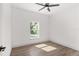 Bright bedroom with window and wood-look floors at 5 Emerald Trl, Ocala, FL 34472