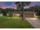 One-story house with attached garage and lush green lawn at 49 Fisher Way, Ocklawaha, FL 32179
