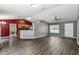 Spacious living room featuring a high ceiling, laminate flooring, and access to the kitchen at 49 Fisher Way, Ocklawaha, FL 32179