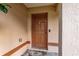 Brown front door entrance with a security system at 49 Fisher Way, Ocklawaha, FL 32179