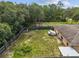 Spacious backyard with wooden fence and large trees at 49 Fisher Way, Ocklawaha, FL 32179