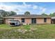 Back exterior of the house and backyard at 49 Fisher Way, Ocklawaha, FL 32179
