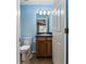 Simple bathroom with wood vanity and toilet at 49 Fisher Way, Ocklawaha, FL 32179