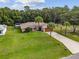 One-story home with palm trees and large backyard at 49 Fisher Way, Ocklawaha, FL 32179