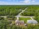 Aerial view showing a house nestled in a wooded area at 49 Fisher Way, Ocklawaha, FL 32179
