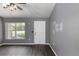Living room with gray walls, vinyl flooring, and white door at 49 Fisher Way, Ocklawaha, FL 32179