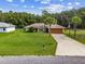 Single story home with attached garage and a basketball hoop at 49 Fisher Way, Ocklawaha, FL 32179