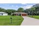 House exterior with a large yard and basketball hoop at 49 Fisher Way, Ocklawaha, FL 32179