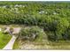 Aerial view showing house and large lot with surrounding trees at 49 Fisher Way, Ocklawaha, FL 32179