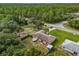 Aerial view of a house with a large backyard and surrounding trees at 49 Fisher Way, Ocklawaha, FL 32179