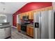 Modern kitchen with stainless steel appliances and wood cabinets at 49 Fisher Way, Ocklawaha, FL 32179