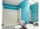 Bathroom with light blue walls and a tub shower combo at 49 Fisher Way, Ocklawaha, FL 32179