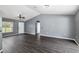 Gray-walled living room with dark flooring and ceiling fan at 49 Fisher Way, Ocklawaha, FL 32179