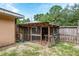 Backyard with wooden enclosure and fenced area at 49 Fisher Way, Ocklawaha, FL 32179