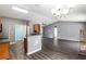 Open kitchen with breakfast bar and stylish gray flooring at 49 Fisher Way, Ocklawaha, FL 32179