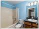 Clean bathroom with light blue walls and a tub shower combo at 49 Fisher Way, Ocklawaha, FL 32179
