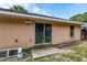 Back exterior view of the house with sliding glass door at 49 Fisher Way, Ocklawaha, FL 32179