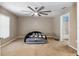 Spacious bedroom with ceiling fan and plush carpeting at 49 Fisher Way, Ocklawaha, FL 32179