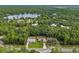 Aerial view showing house, lake, and surrounding area at 49 Fisher Way, Ocklawaha, FL 32179