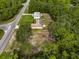 Aerial view of house, yard, and surrounding trees at 49 Fisher Way, Ocklawaha, FL 32179