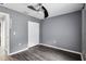 Bedroom with grey walls, laminate flooring and double doors at 49 Fisher Way, Ocklawaha, FL 32179