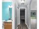 Clean hallway with grey walls and laminate flooring at 49 Fisher Way, Ocklawaha, FL 32179