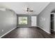 Living area with gray walls, dark flooring, and sliding glass doors at 49 Fisher Way, Ocklawaha, FL 32179